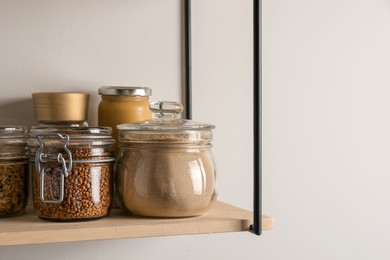 Flour and buckwheat in glass jars on shelf