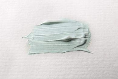 Photo of Sample of light green paint on white canvas