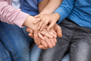 Closeup view of happy family holding hands