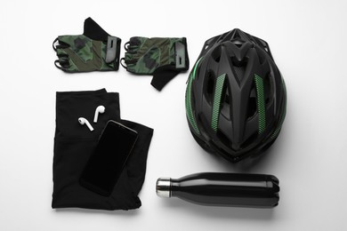 Flat lay composition with different cycling accessories and clothes on white background