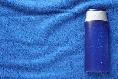 Men's personal hygiene product on blue soft towel, top view. Space for text