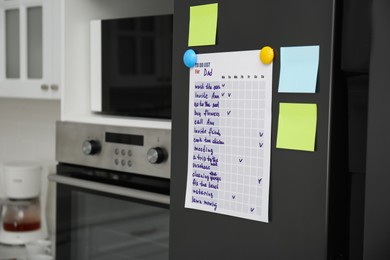To do list and sticky notes on fridge in kitchen. Space for text