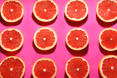 Flat lay composition with tasty ripe grapefruit slices on magenta background
