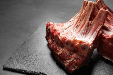 Raw ribs on slate board, closeup. Fresh meat