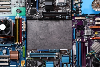 Frame of computer motherboards on grey table, flat lay with space for text. Electronic device
