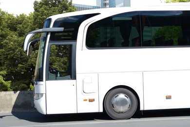 Modern white bus on road outdoors. Public transport