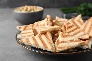 Photo of Delicious pita chips on grey table, closeup