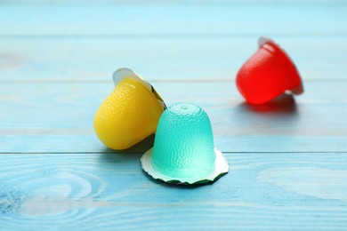 Tasty bright jelly cups on light blue wooden table