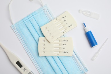 Disposable express test kit for hepatitis on white background, flat lay