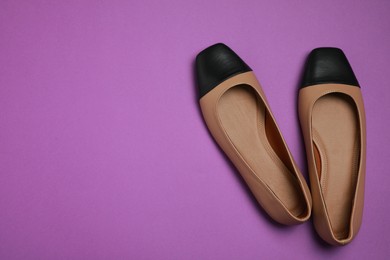 Photo of Pair of new stylish square toe ballet flats on purple background, flat lay. Space for text