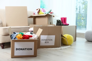 Carton boxes with donations in living room