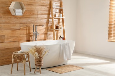 Bathroom interior with white tub and decor near wooden wall