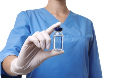 Female doctor holding ampule with vaccine on white background, closeup. Medical object