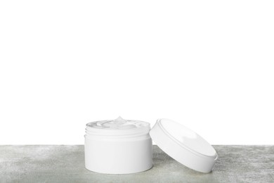 Jar of hand cream on gray table against white background