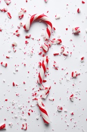 Crushed candy cane on white background, top view. Traditional Christmas treat