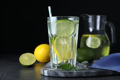 Delicious lemonade made with soda water and fresh ingredients on grey table