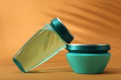 Hair care cosmetic products on orange background