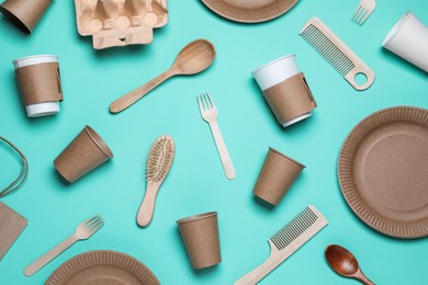 Photo of Different eco items on turquoise background, flat lay. Recycling concept