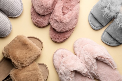 Different soft slippers on beige background, flat lay