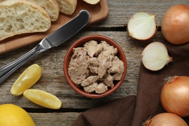 Photo of Flat lay composition with tasty cod liver and different products on wooden table