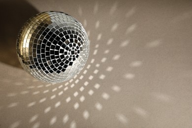 Photo of Shiny disco balls on light grey background, top view. Space for text