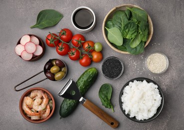 Photo of Ingredients for poke bowl on grey table, flat lay