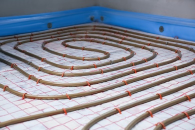 Installation of underfloor heating system in building