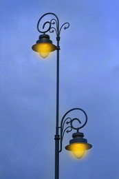 Beautiful old fashioned street lamps lighting outdoors