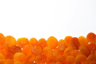 Dried apricots on white background, top view with space for text. Healthy fruit