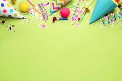 Beautiful flat lay composition with festive items on light green background, space for text. Surprise party concept