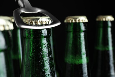 Photo of Opening bottle of tasty cold beer, closeup. Space for text