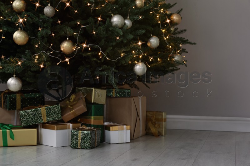 Beautifully decorated Christmas tree and gifts indoors