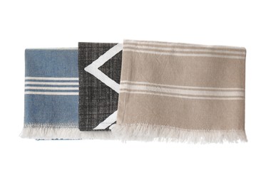 Kitchen towels with different patterns hanging on white background