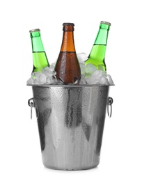 Photo of Metal bucket with bottles of beer and ice cubes isolated on white