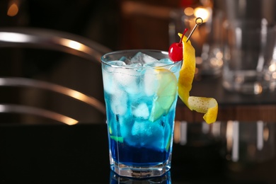Blue Lagoon cocktail on black table in bar