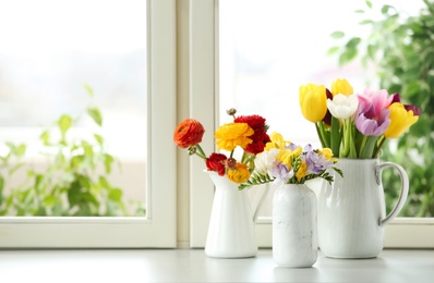 Photo of Different beautiful spring flowers on window sill. Space for text