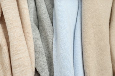 Photo of Different cashmere clothes as background, closeup view