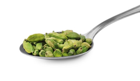 Spoon full of cardamom on white background, closeup
