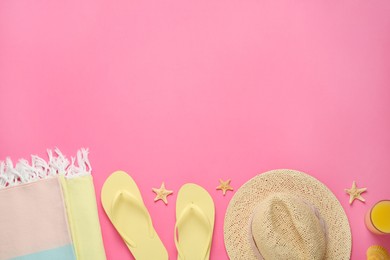 Flat lay composition with different beach objects on pink background, space for text