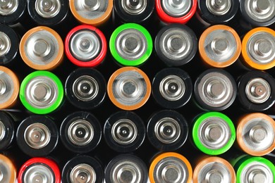 Many different batteries as background, top view