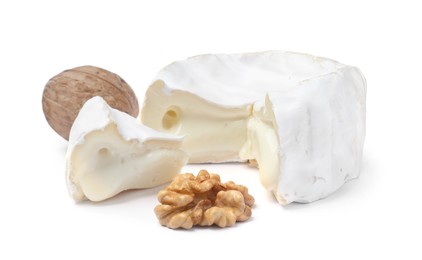 Tasty cut brie cheese with walnuts on white background