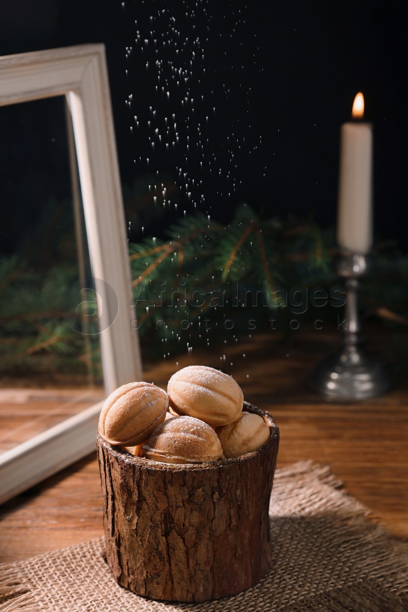Photo of Homemade walnut shaped cookies with boiled condensed milk on wooden table, space for text