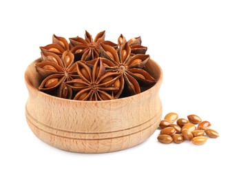 Wooden bowl with dry anise stars and seeds on white background