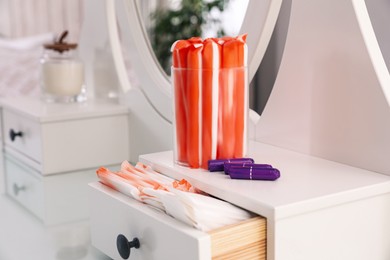 Dressing table with different feminine hygiene products indoors