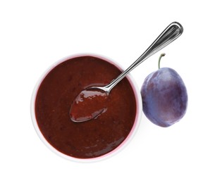Plum puree in bowl and fresh fruit on white background, top view