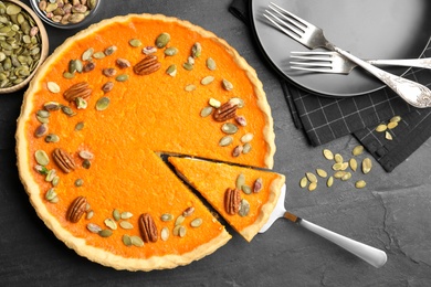 Delicious homemade pumpkin pie on black table, flat lay