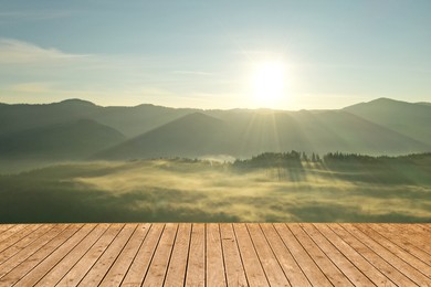 Empty wooden surface and beautiful view of misty mountain landscape