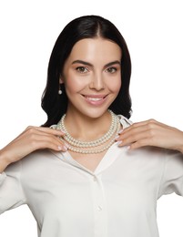 Young woman wearing elegant pearl jewelry on white background
