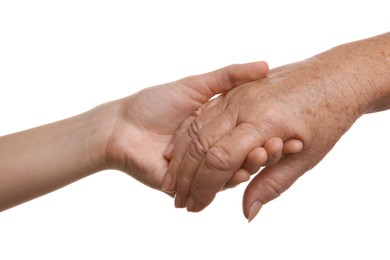 Young and elderly women holding hands together on white background, closeup