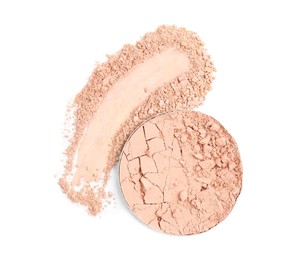 Broken face powder and swatch on white background, top view